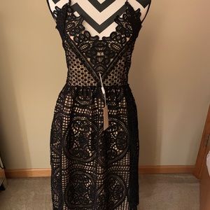 Mid length Black lace halter dress with open back